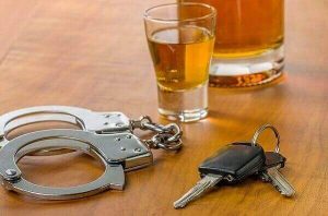 dwi - handcuffs, car keys, and shot glass